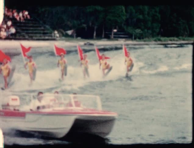 A group of women water skiing behind a boat