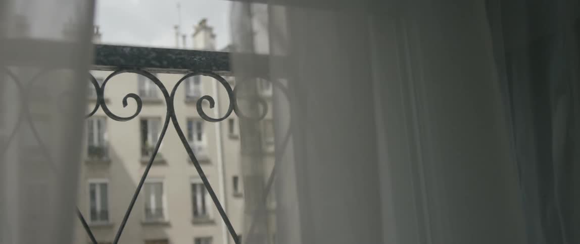 The drape is partially closed on this window
