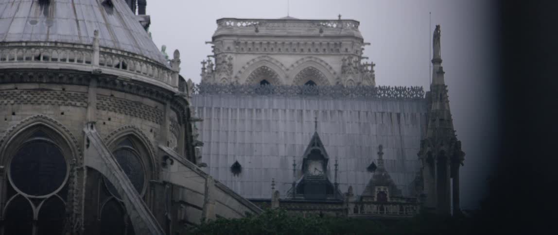 A large stone building sits in a cloudy sky