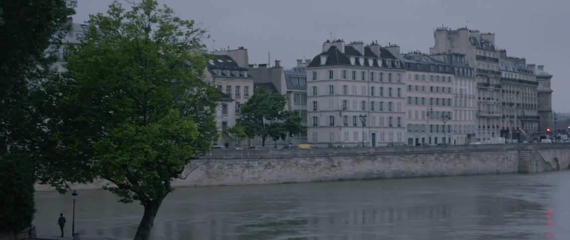 Several large buildings sit across a river