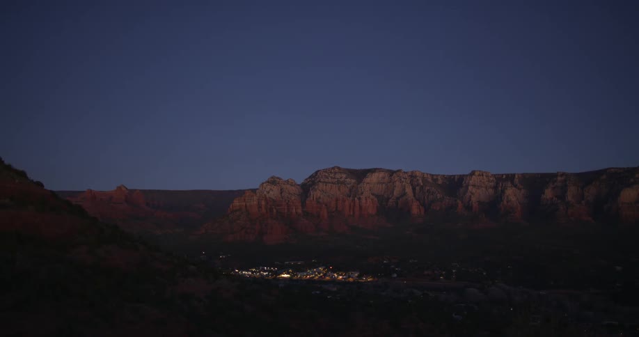 A small town with a cliff and the sky in the background