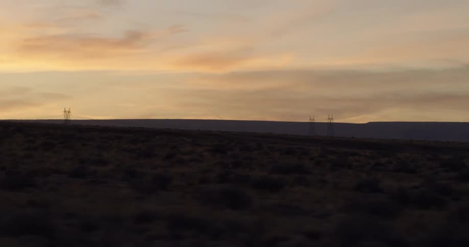 The sun is setting over the fog covered hills ahead