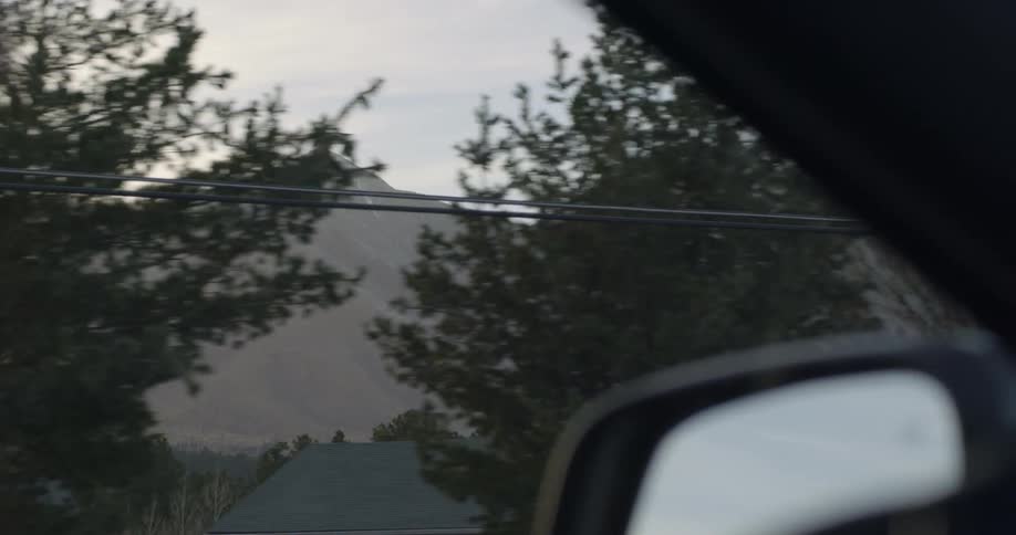 A mountain range runs parallel to a roadway