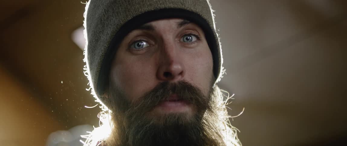 Man with beard in beanie gazing