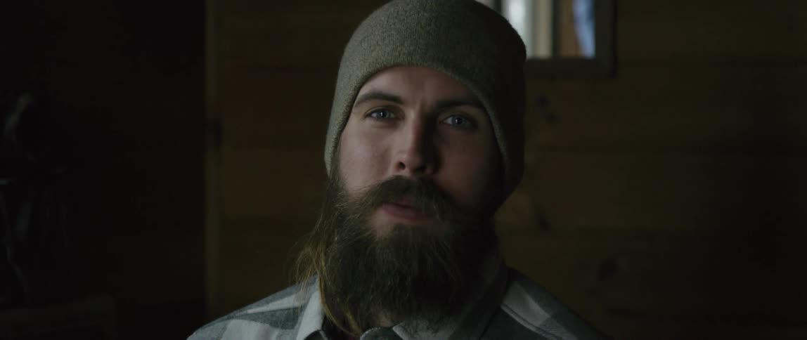 A bearded man wears a beanie