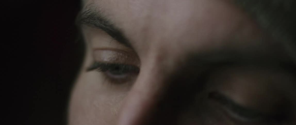 A woman is shifting her gaze to look upward
