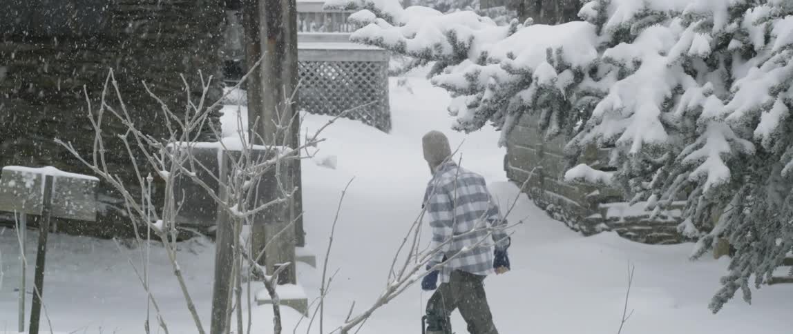 Man walks outside in a snowstorm