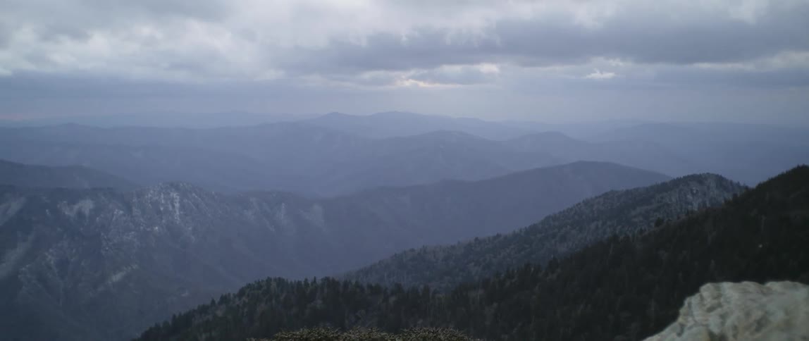 Clouds float above mountains in the wilderness