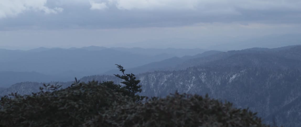 Man In Mountain Log Cabins During Winter