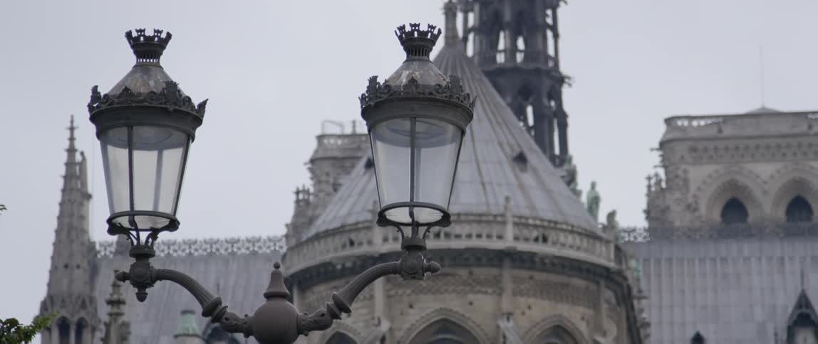 An old fashioned street lamp stands in front of a cathedral