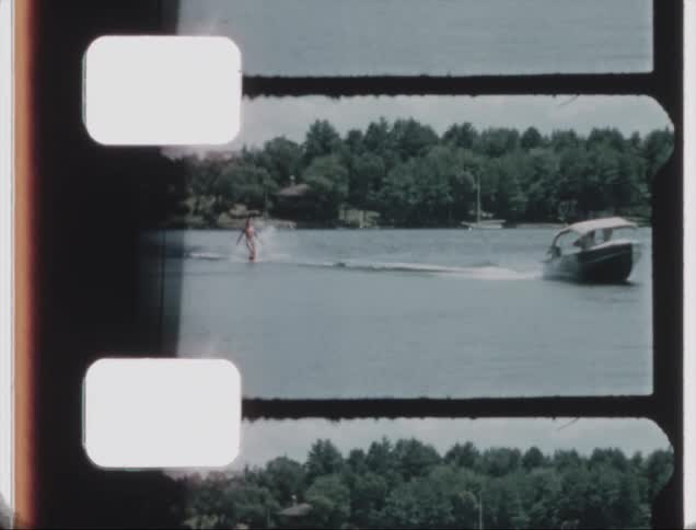 A man water skis being a boat on the coast during the day