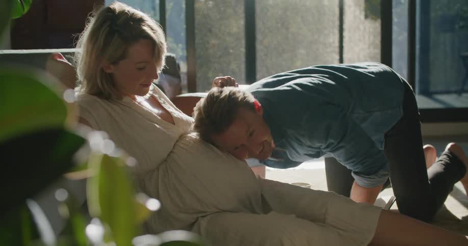 Father listens to mothers pregnant abdomen