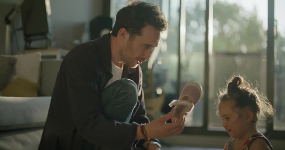 A father giving his daughter shoes