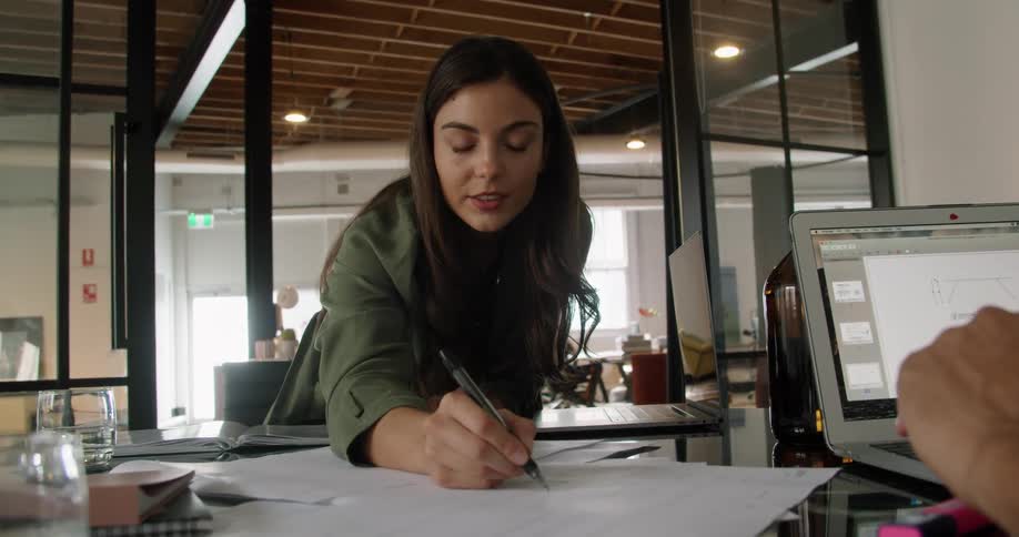 Woman amends document during discussion