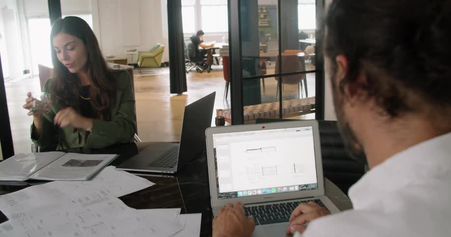 A man and woman working together in an office