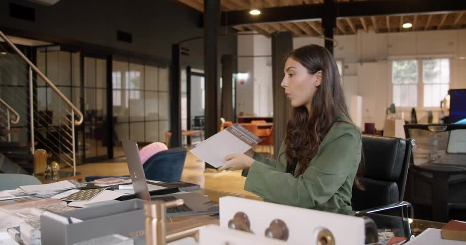 A woman is talking and reading from a piece of paper