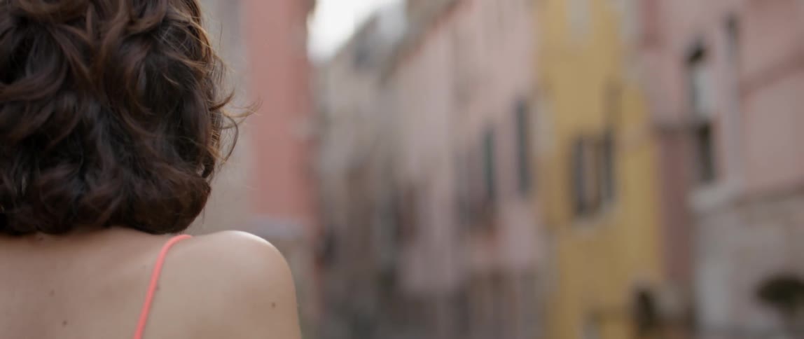 A woman looks over a canal in the day time