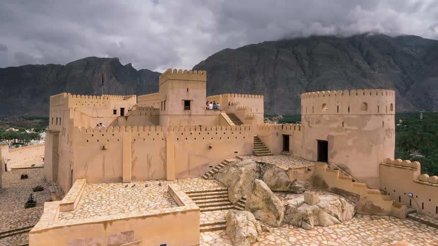Timelapse of people visiting a castle near the mountains