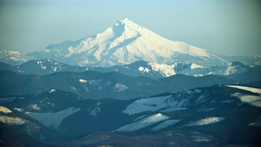 Mount Jefferson in Oregon near Bend rises high above the valley floor on a brilliant clear day in the middle of winter