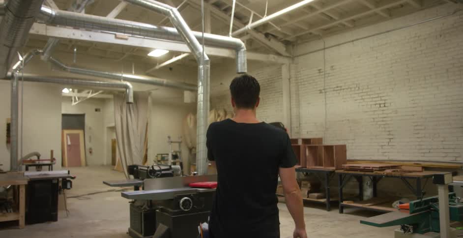 Carpenter walking through workshop