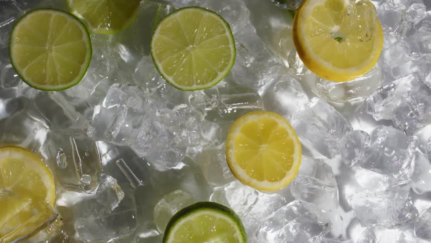 Lemon and lime slices with water and ice