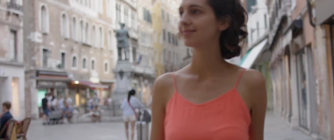 A woman walks around smiling