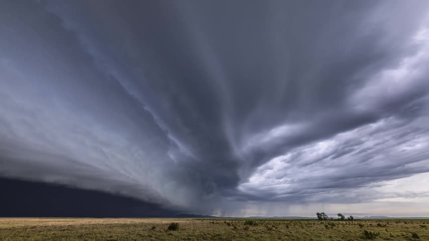 Dark storm clouds move over farm land