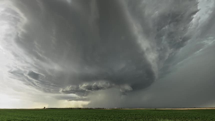 Clouds spin as they flow across crop fields