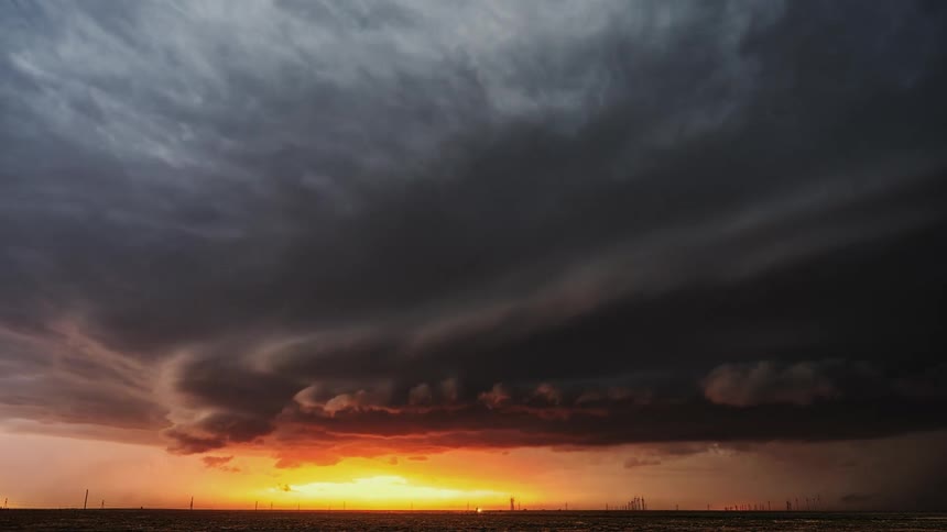 The storm clouds move fast as the sun sets