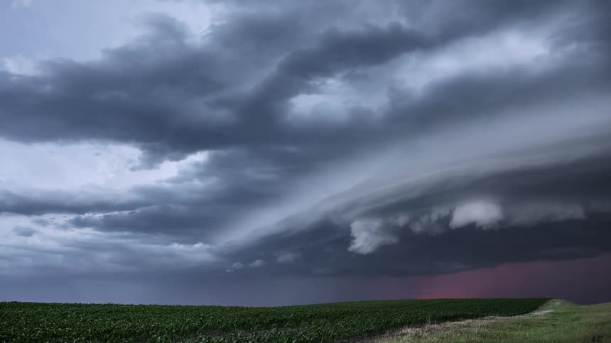 Lightning flashes in the sky as dark storm clouds roll in