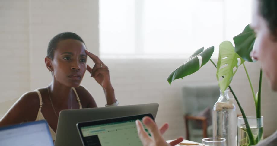 Two workers in an office using computers