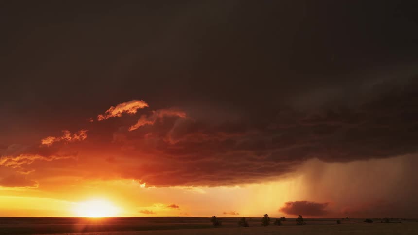 Time lapse of storm clouds moving over a grassland