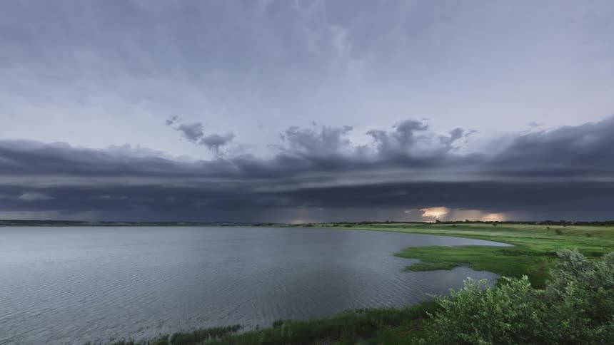 Dark clouds move over lake and shoreline
