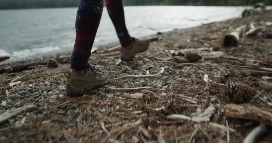 A woman walking around outdoors next to a river