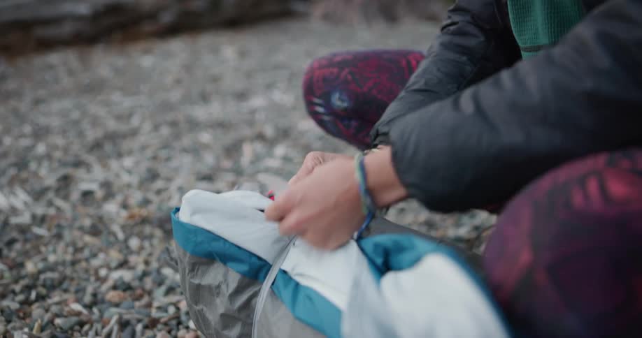 A woman tying up things while camping