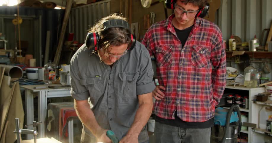 Two workers working with wood in a shop