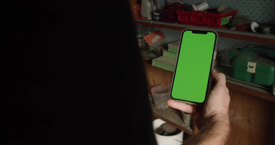 A man is using a cell phone inside