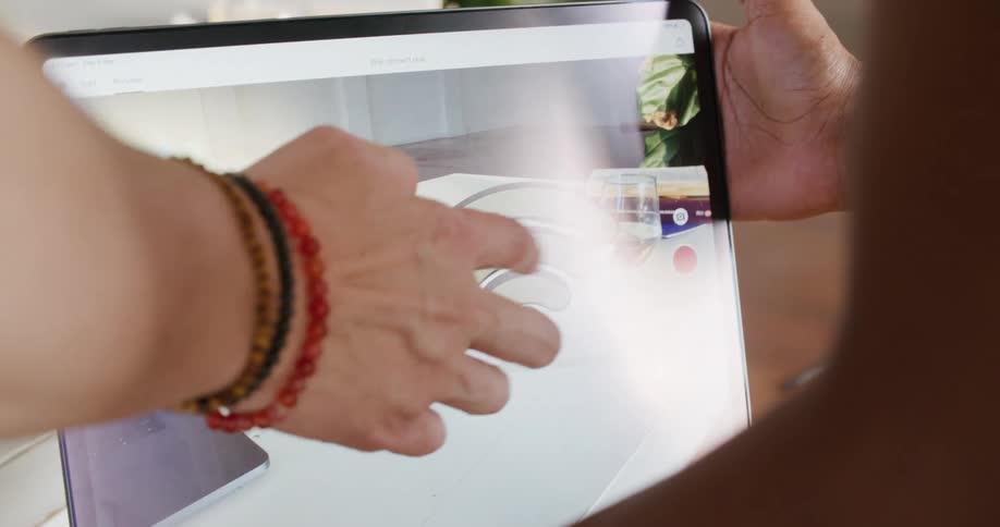 Person holds screen while another taps touchscreen