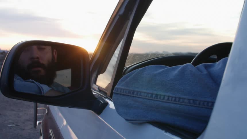 A man is sitting in his vehicle