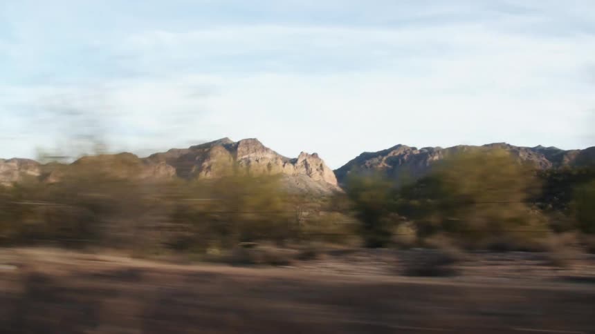 Signs line the road that runs alongside a canyon