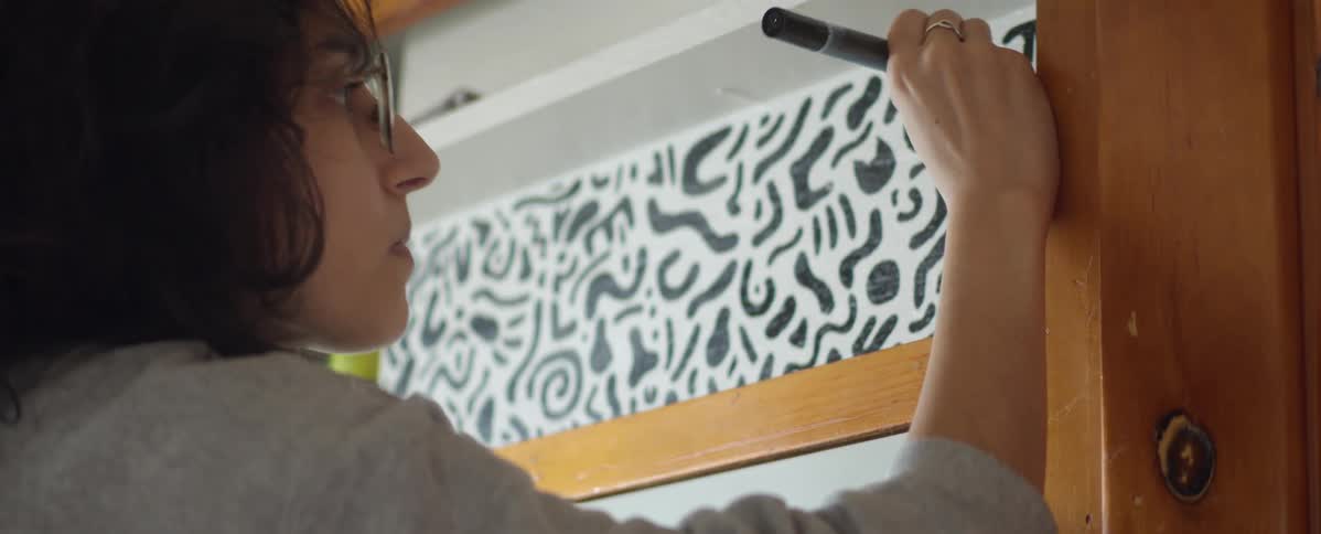 A woman is doing artwork indoors