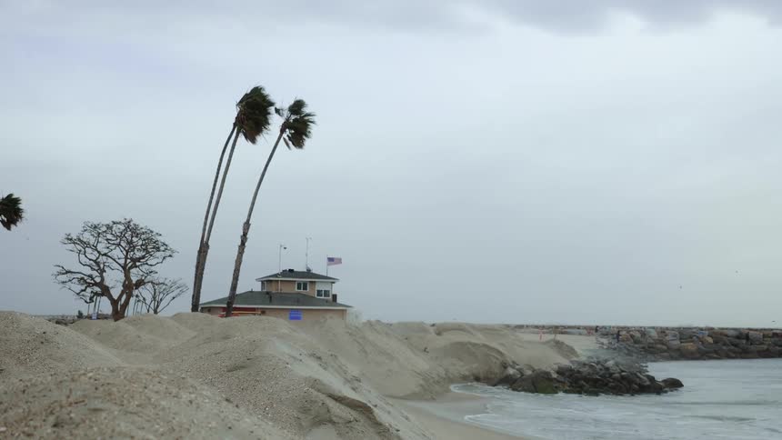 Waves hitting beach on stormy coast