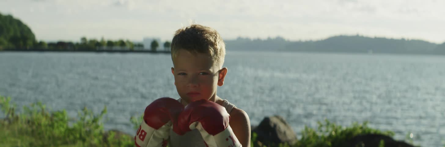A child that is putting up boxing gloves