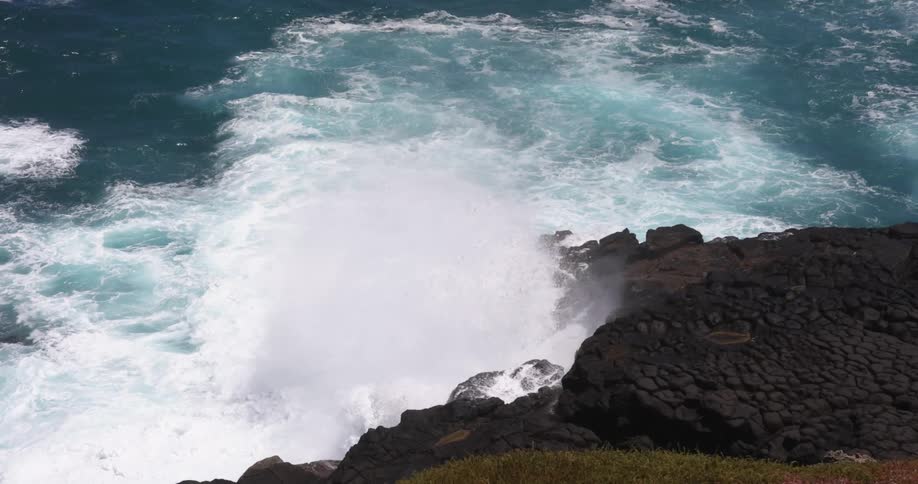 Waves crashing in to rocks on the shore
