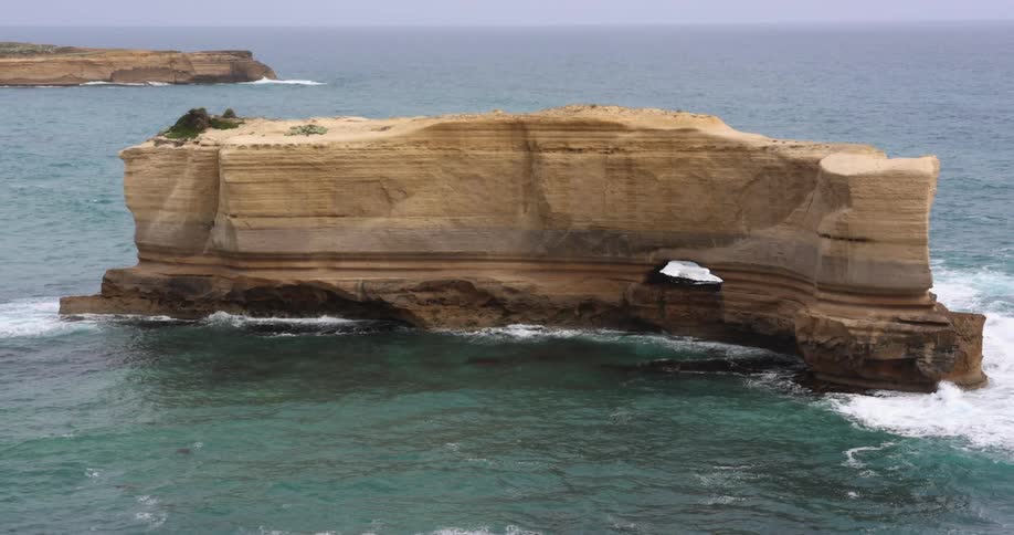 Aerial view of an ocean and island is displayed