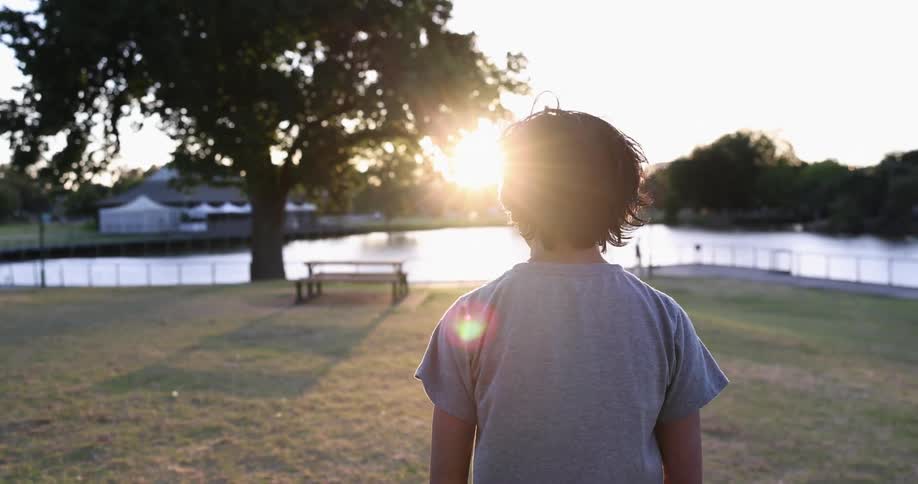 A child that is walking through a park