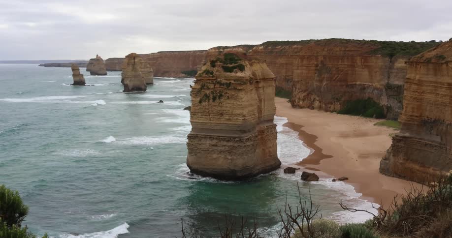 Rock promontories rising over the a beach coastline close to a cliff