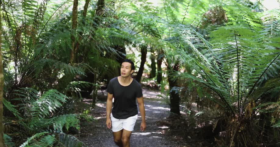 A man that is walking up a hill outdoors