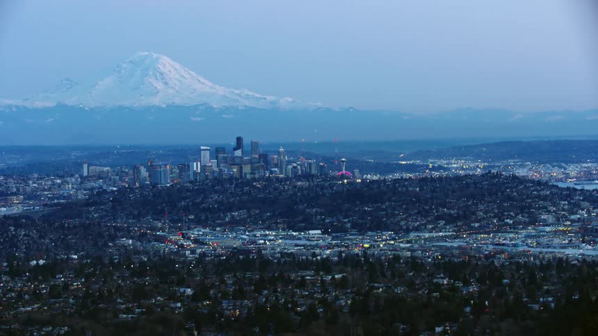 Blue hour aerial of downtown Seattle and Mount Rainier from 5,000 feet above the city after the sun has set on a brilliant clear evening