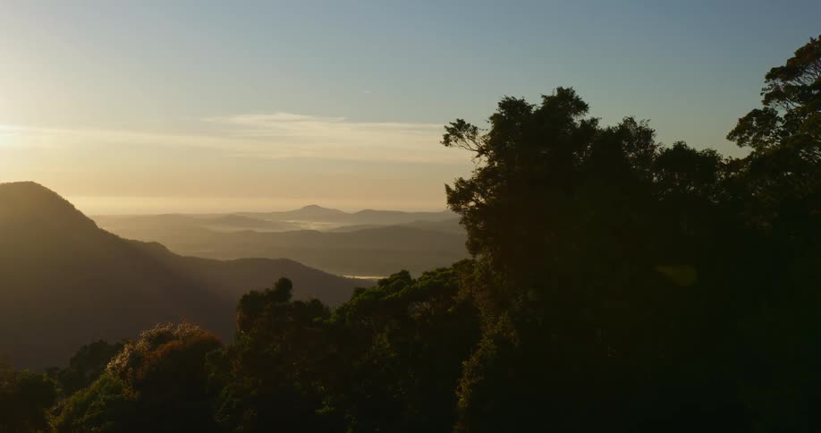The sun is rising behind the mountain